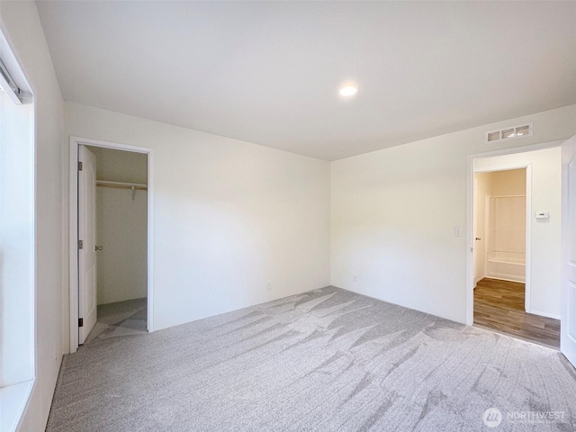 unfurnished room featuring recessed lighting, visible vents, and carpet flooring