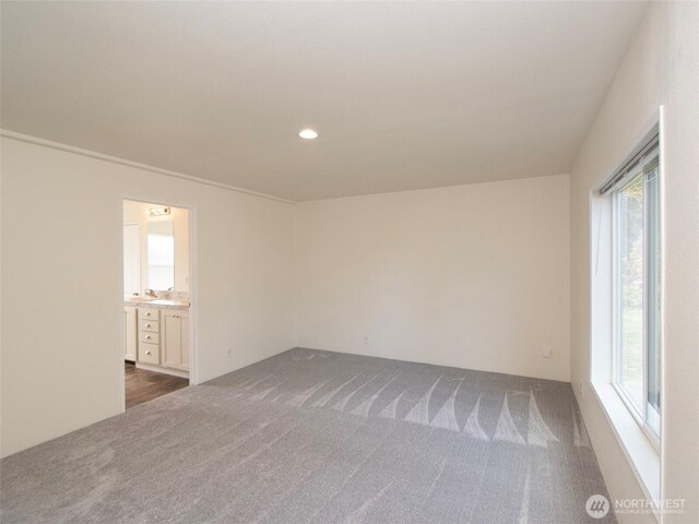 unfurnished room with recessed lighting and dark carpet