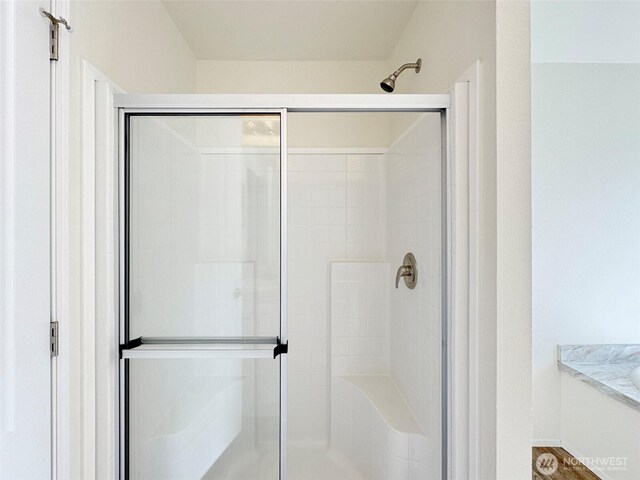 full bath with a shower stall