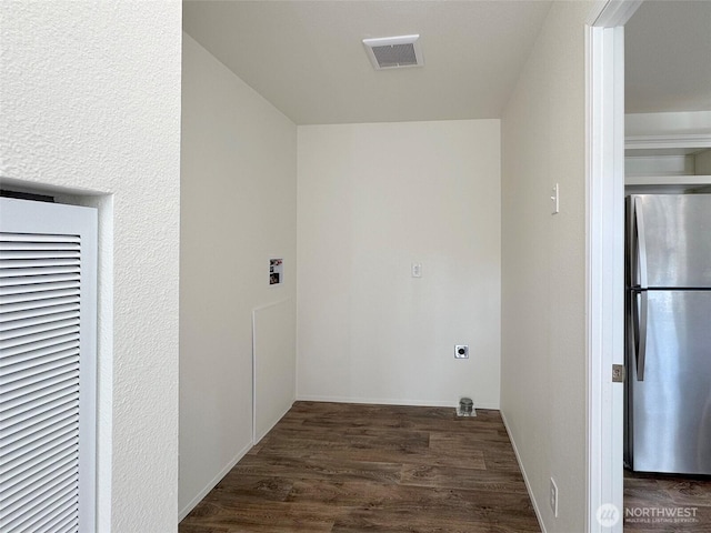 clothes washing area with visible vents, wood finished floors, hookup for an electric dryer, a heating unit, and laundry area