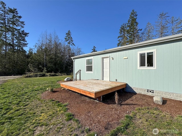 rear view of house with crawl space, a lawn, and a wooden deck