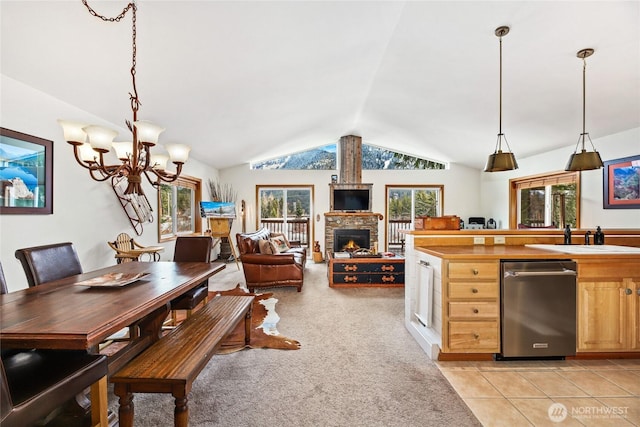 dining room featuring light carpet, a fireplace, light tile patterned floors, a chandelier, and vaulted ceiling