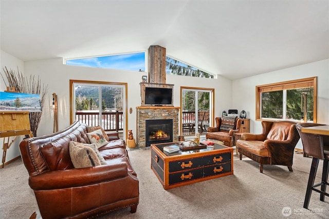 living area with lofted ceiling, a fireplace, and carpet floors