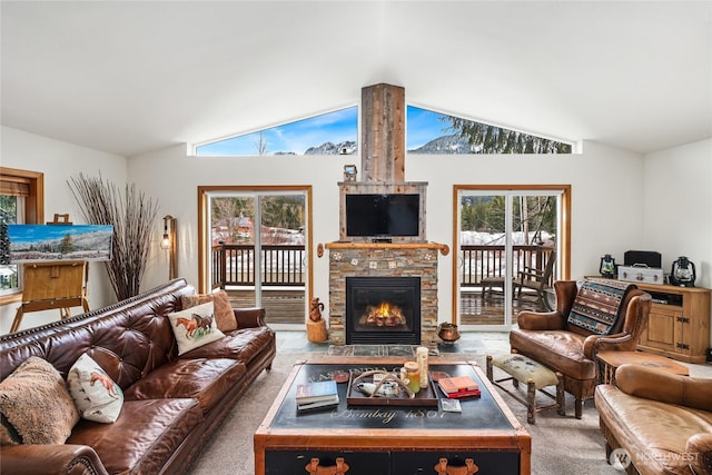 carpeted living area featuring lofted ceiling and a fireplace