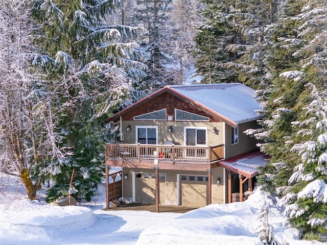 chalet / cabin featuring metal roof and an attached garage