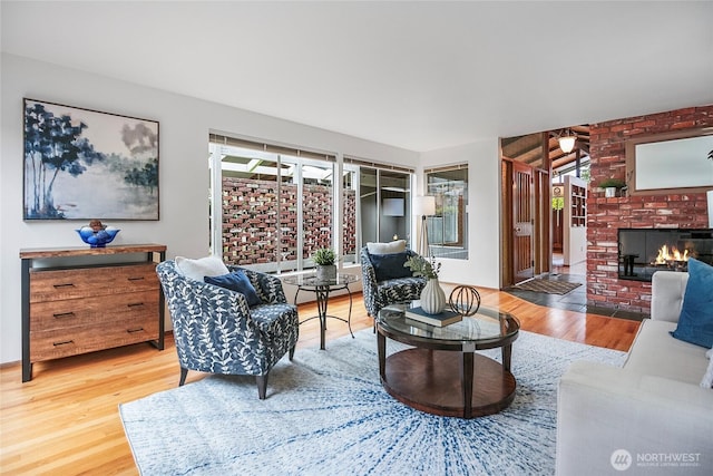 living area with a fireplace and wood finished floors