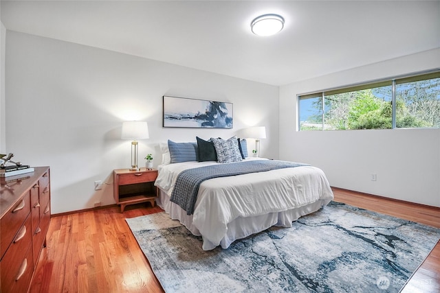 bedroom featuring light wood-style flooring and baseboards