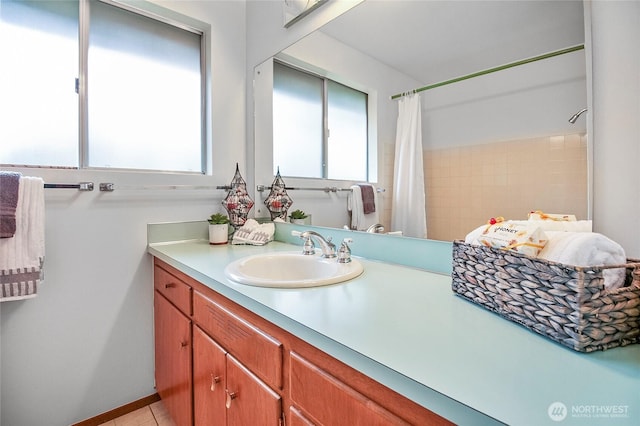 bathroom featuring tile patterned flooring, curtained shower, and vanity