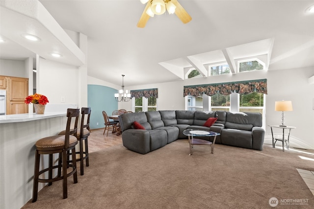 living area with vaulted ceiling, recessed lighting, ceiling fan with notable chandelier, and light carpet