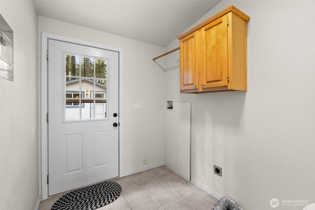 laundry room with light tile patterned floors, cabinet space, electric dryer hookup, and baseboards