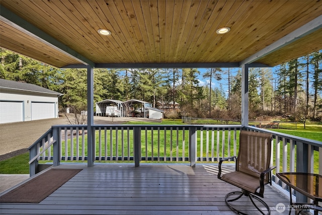 deck featuring an outdoor structure and a yard