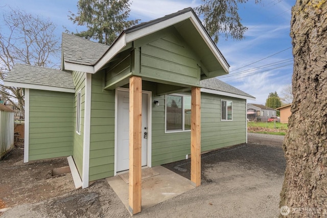 exterior space featuring a shingled roof