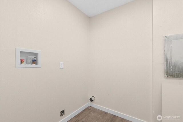 washroom with washer hookup, laundry area, wood finished floors, and baseboards