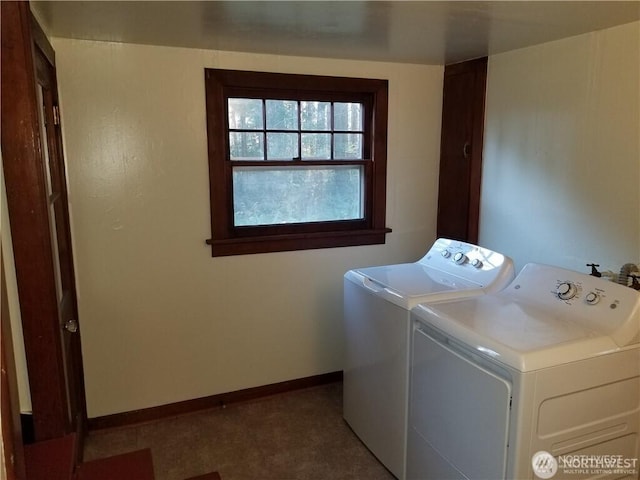 washroom featuring laundry area, washing machine and dryer, and baseboards