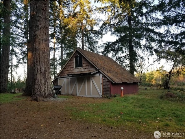 view of barn with a lawn