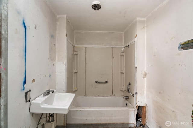 full bathroom featuring ornamental molding, washtub / shower combination, and a sink