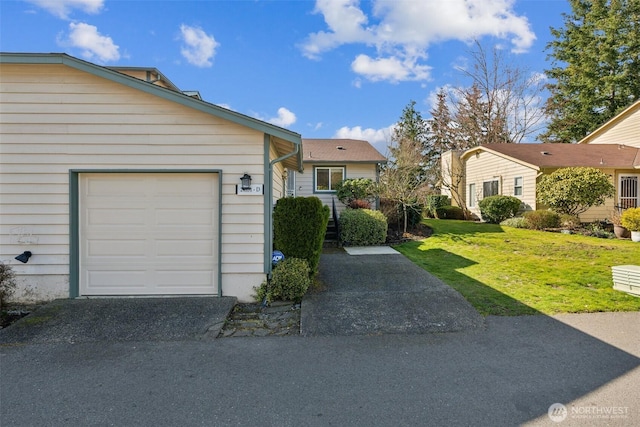 view of front of house featuring a garage and a front lawn