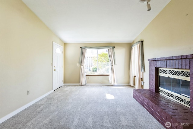 unfurnished living room featuring a brick fireplace, baseboards, and carpet floors