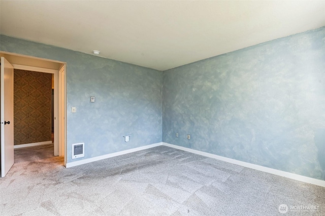 unfurnished room with carpet flooring, visible vents, and baseboards