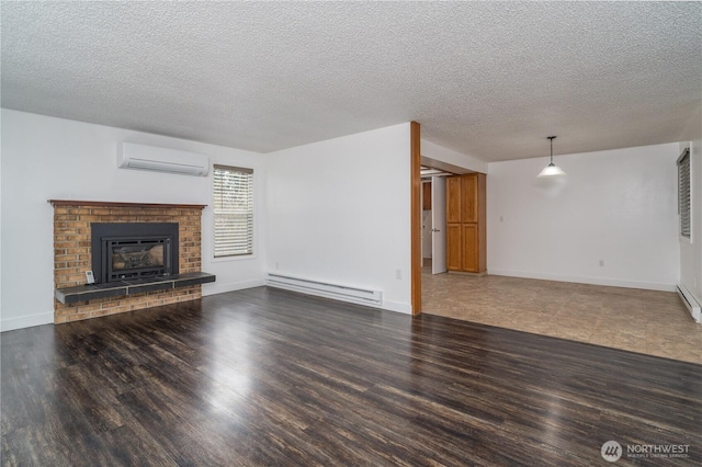 unfurnished living room with a baseboard heating unit, wood finished floors, a wall mounted air conditioner, and a fireplace