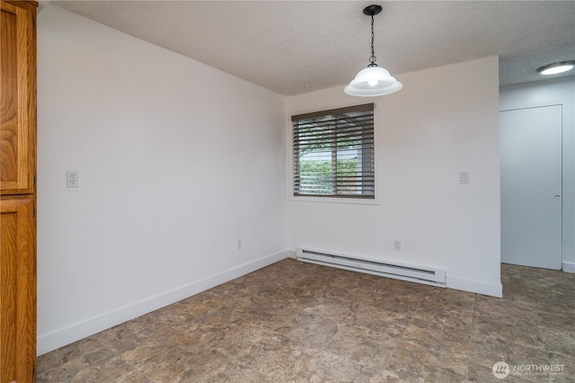 unfurnished room with a baseboard heating unit, baseboards, a textured ceiling, and stone finish flooring