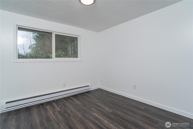 empty room featuring a baseboard heating unit, baseboards, a textured ceiling, and dark wood-style floors