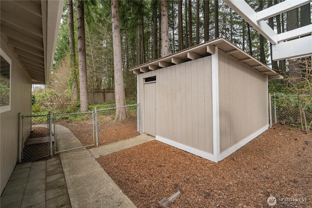 view of shed with a gate and fence