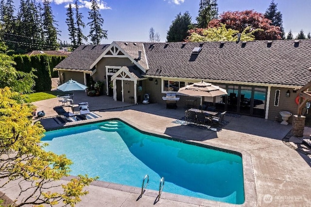 pool featuring outdoor dining space and a patio area