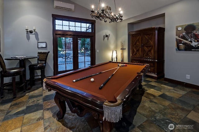 rec room with stone finish flooring, french doors, a wall mounted AC, and baseboards