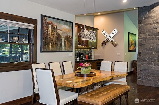 dining area with recessed lighting, wood finished floors, and a dry bar