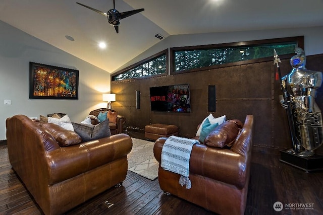 home theater room with visible vents, wood-type flooring, ceiling fan, and vaulted ceiling