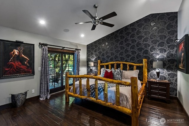 bedroom with wallpapered walls, an accent wall, baseboards, vaulted ceiling, and hardwood / wood-style flooring