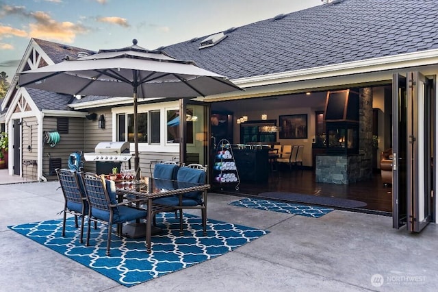 view of patio featuring outdoor dining area and a grill