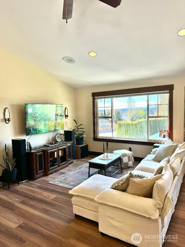 living area with recessed lighting, lofted ceiling, wood finished floors, and a ceiling fan