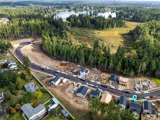 drone / aerial view with a view of trees and a water view