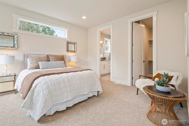 bedroom featuring visible vents, baseboards, recessed lighting, light carpet, and connected bathroom