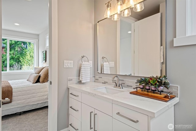 bathroom featuring vanity, recessed lighting, tasteful backsplash, and ensuite bathroom