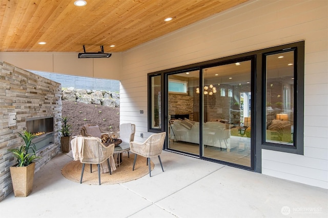 view of patio / terrace featuring a glass covered fireplace and outdoor dining space