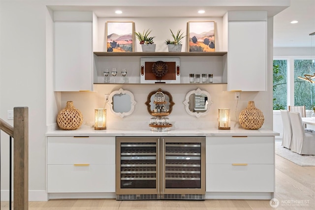 bar with a bar, wine cooler, and recessed lighting