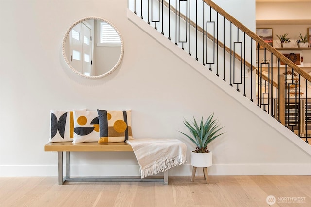 stairs with baseboards and wood finished floors