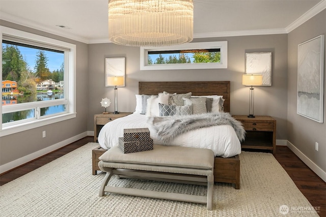 bedroom with multiple windows, wood finished floors, and ornamental molding