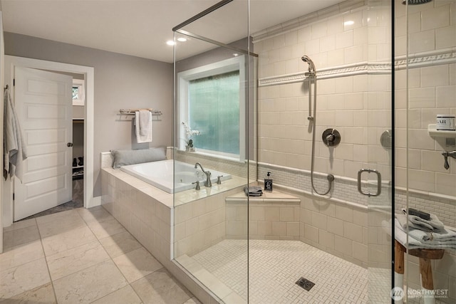 bathroom featuring a bath and a stall shower