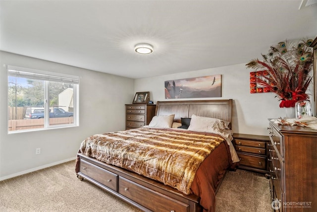 bedroom with baseboards and carpet