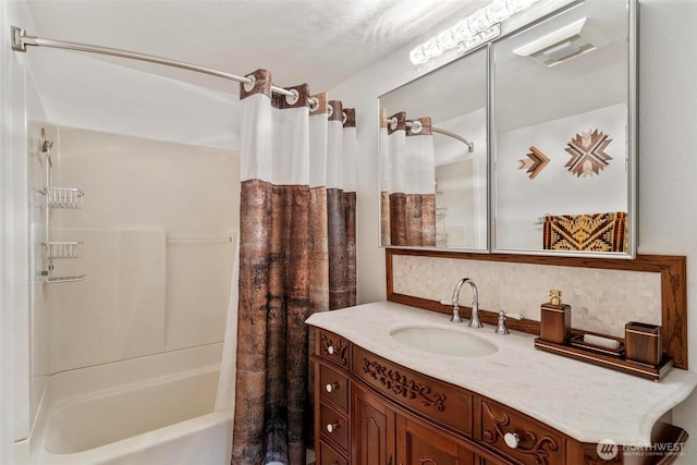 bathroom with vanity, visible vents, and shower / bath combo with shower curtain