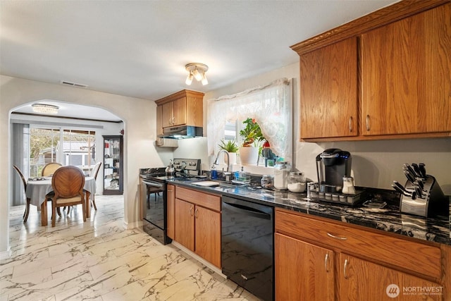 kitchen featuring visible vents, a sink, black appliances, under cabinet range hood, and marble finish floor