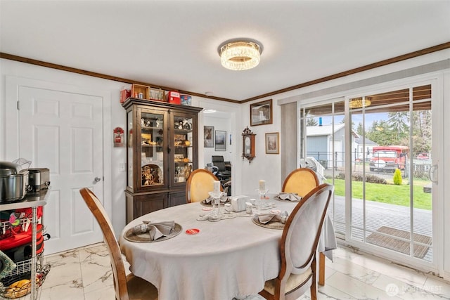 dining area featuring marble finish floor and ornamental molding