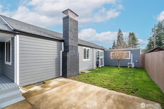 rear view of property featuring ac unit, a patio, fence, a yard, and a chimney