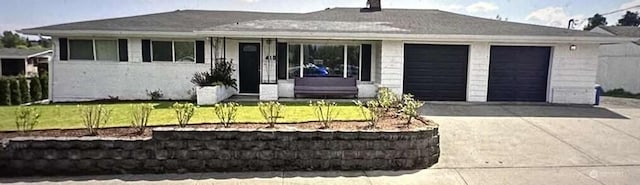 ranch-style house with a garage and concrete driveway