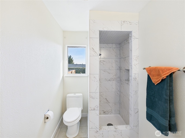 bathroom featuring tile patterned flooring, a shower stall, toilet, and baseboards