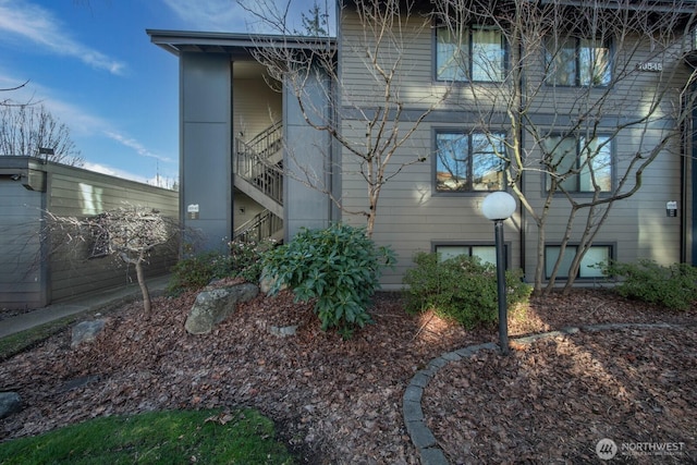 view of side of home with stairs